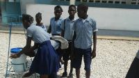 Students at a secondary school in southeast Haiti wash their hands after an awareness-raising session organised by HI's local partner, RANIPH (Réseau Associatif National pour l’Intégration des Personnes Handicapées).